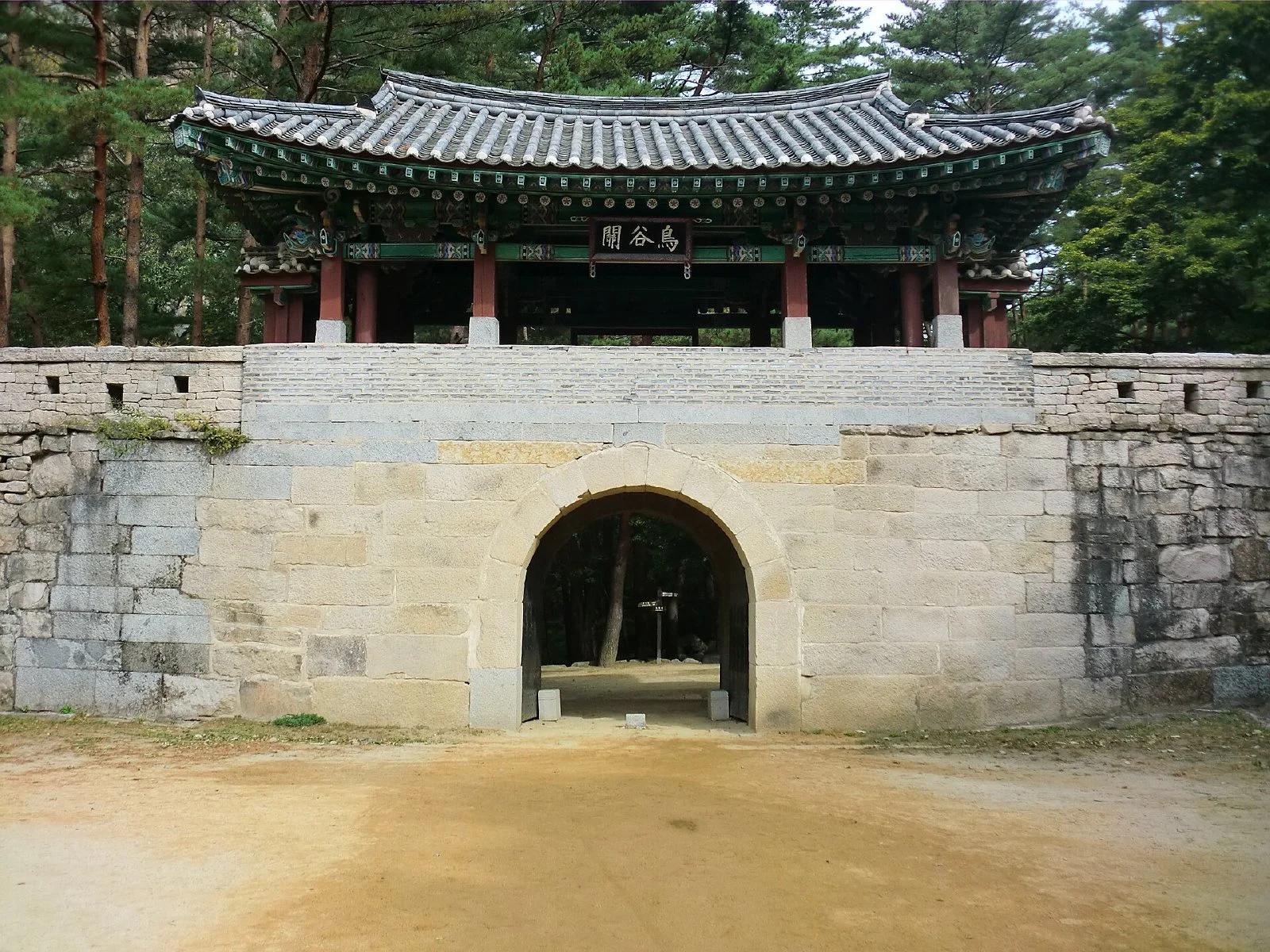 숲길 위에 서 있는 문경새재 조령 제2관문 조곡관 돌문과 누각